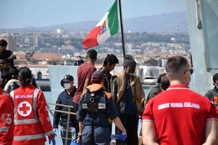 Migranti e uomini della Croce Rossa